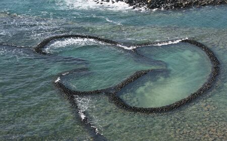 This is a double hearted fishing weir.  It's from Penghu, Islands that are off the coast of Taiwan.  This fishing method uses the tide to catch fish.の写真素材