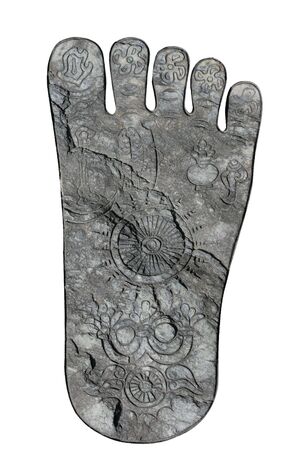 Buddha's footprint on a rock.  This is from Japan.  It has been isolated from it's background. の写真素材
