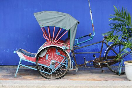 This is an old cycle rickshaw from Penang. It's a classic symbol of old Penang and Asia.の写真素材
