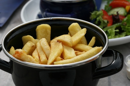 Chips or French fries in a pot and served with a meal. の写真素材