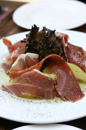 Ham and Melon dish with some salad.  This is a popular European dish.の写真素材
