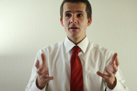 Manager explaining his business   He uses his hands to explain の写真素材