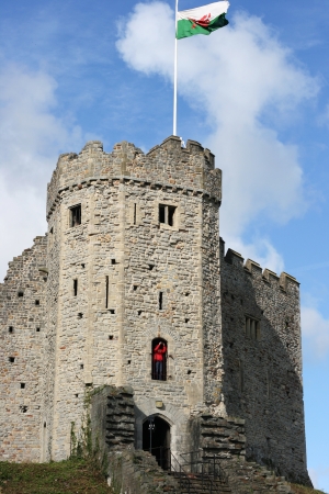 Cardiff castle on a sunny day, with the Welsh flag flying about it  のeditorial素材