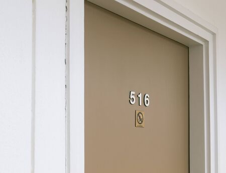 Hotel room door with No Smoking sign
