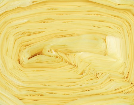 Roll of yellow plastic garbage bagsの写真素材