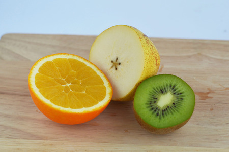 Kiwi, orange and pear cutの写真素材