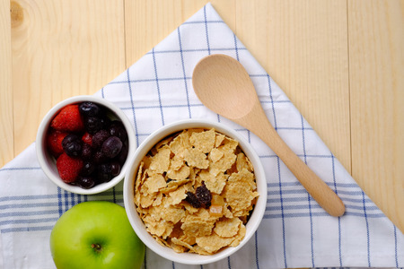 Healthy food top view of muesli isolated dried food and fruit on wood table background, close up, decorated napkin and spoon concept.の写真素材