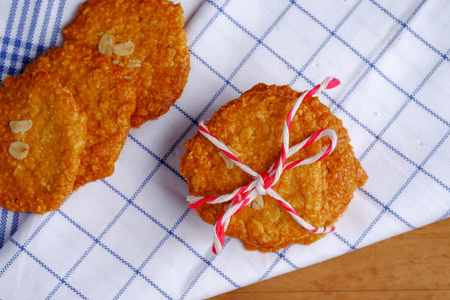 Homemade cashew nut and coconut cookies top view on wood table background, decorated napkin and rope...