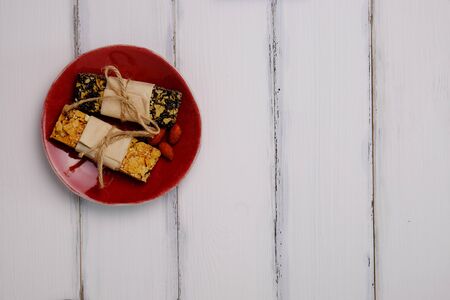Healthy homemade grain bar on white wood table background style, top view.の写真素材