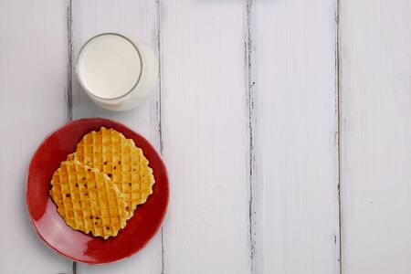 Waffle and milk on white wooden table background style, top view.の写真素材