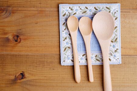 Top view of wood spopn on wood  table background style with space, decorated.の写真素材