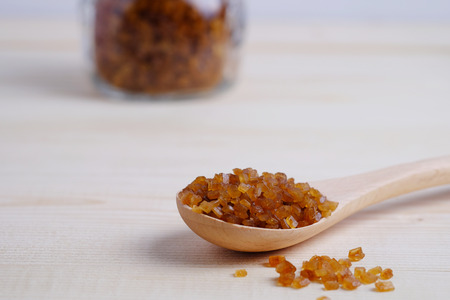 Close up of brown sugar in spoon on wooden table background, selective focus with blank space.の写真素材