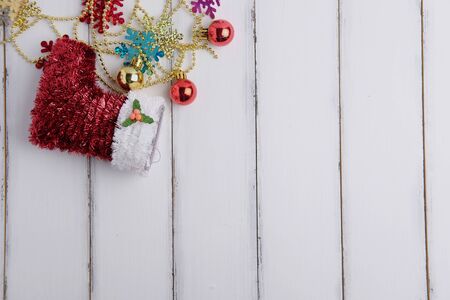 Top view of Happy christmas and Happy new year festival with decoration ornament and sock concept on white wood background. Selective focus and space vintage style.の写真素材