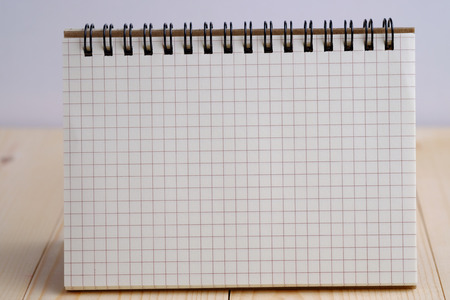Close up of blank with notebook on wooden table and white background concept.の写真素材