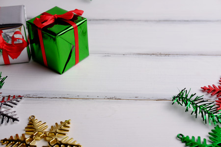 Close up of Merry christmas and Happy new year with gift box concept on white wooden background. Blank space, selective focus and decorated style.の写真素材