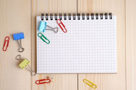 Top view of blank notebook on wood table background concept. Decorated and blank space.