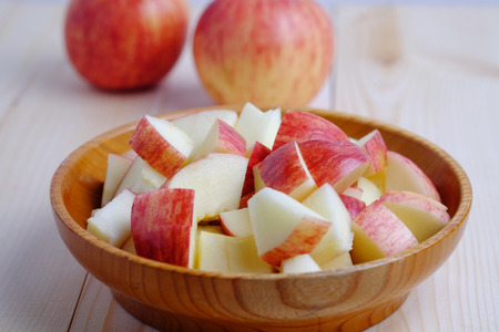 Close up of red apple isolated style on wooden cup and wood table. Selective focus, background and vintage.の写真素材