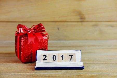 Happy new year 2017 on wood table background concept, decoration with gift box, close up and selective focus.の写真素材