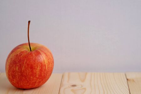 Close up of red apple style on wooden cup and wood table. Blank space, background and vintage.の写真素材