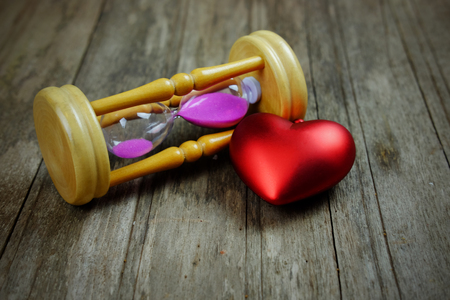 Close up of Hourglass on wood background, vignette effect concept. Time concept and copy space,...