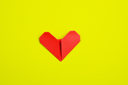 Top view of one red heart  paper on yellow  background idea, selective focus, valentine day.の写真素材