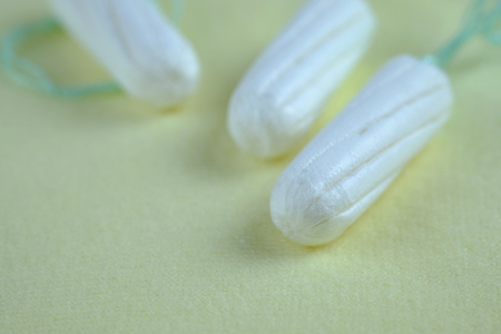 Woman hygiene protection of healthy with cotton tampons on yellow background, woman menstruation cycle, critical day, selective focus and copy space.の写真素材