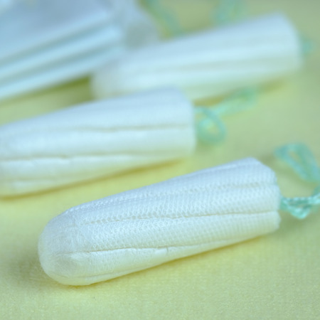 Woman hygiene protection of healthy with cotton tampons on yellow background, woman menstruation cycle, critical day, selective focus and copy space.の写真素材