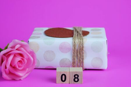 Close up of Pink rose and gift box on pink background, women's day concept. Love and copy space,...