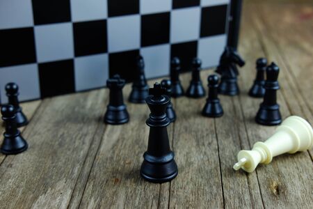 Close up of chess with black king on board. Business concept able to survive or dominant from...