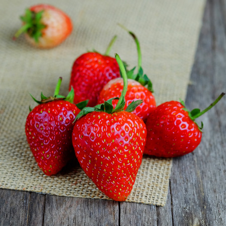 Close up of Fresh strawberries on wood table background concept, selective focus and vintage style.の写真素材
