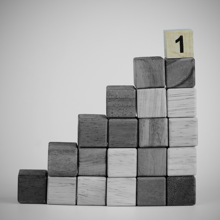 One wood block step stair, black and white tone background. Business concept for growth success process. Selective focus on the top step, copy space, vignette effect.の写真素材