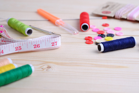 Vintage background with sewing kit and accessories for needlework on wooden background. Blank space and close up concept.の写真素材