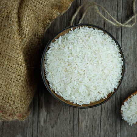 Top view of rice in a bowl on wood background, thai food, selective focus and vignette effect concept.の写真素材