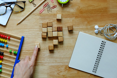 Office desk wooden table with abacus, notebook, decoration. Business planning concept, copy space,...