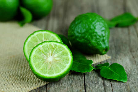 Fresh of bergamot isolated on wooden table. Selective focus and copy space.