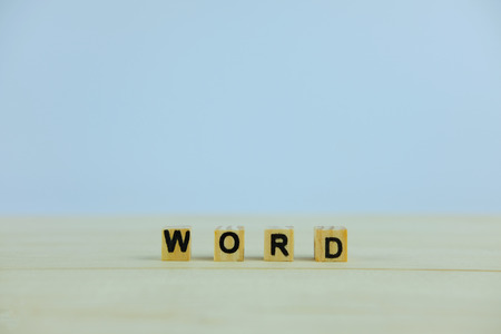 Wooden block for Word concept on wood and white background, close up and selective focus.の写真素材