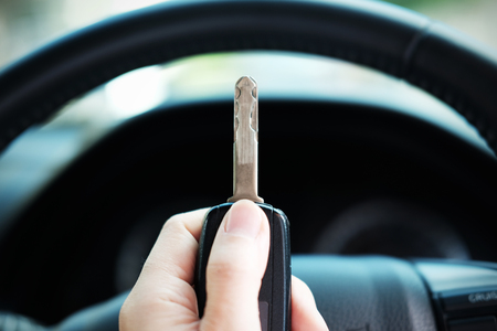 Close up of Car key with remote control in hand, selective focus and vignette effect.の写真素材