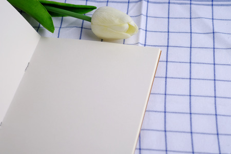 Close up of blank with notebook on tablecloth background concept, flower decorated style.の写真素材