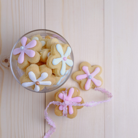 Top view of flower cookies in cup on wood table concept, selective focus and copy space.の写真素材