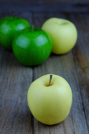 Close up of Fresh golden apple on wooden table background concept, selective focus and copy space.の写真素材