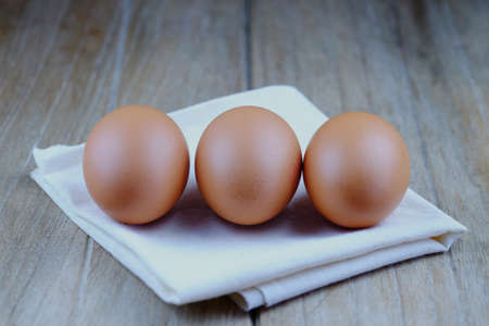 Close up of fresh eggs on wood table background concept, selective focus, vintage style.の写真素材