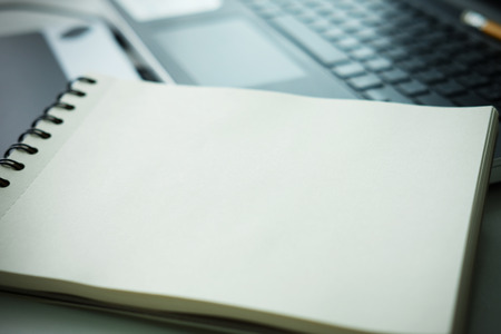 Close up of Blank open notebook on desk business lifestyle concept, selective focus and vignette effectの写真素材
