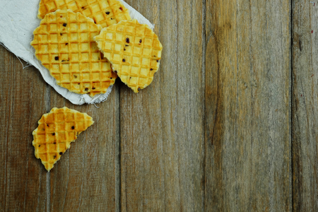 Sweet waffle on napkin and wood table background concept, top view, copy space.の写真素材