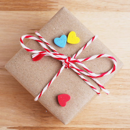 Gift box in important day on wooden background, top view.
