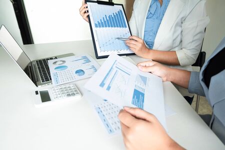 Two leader business women discussing the charts and graphs showing the results.の写真素材