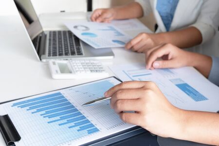 Two business leader women discussing the charts and graphs showing the results.の写真素材