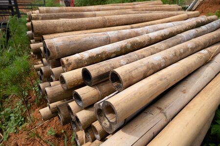 brown bamboo pile prepare for construction building materials.の写真素材