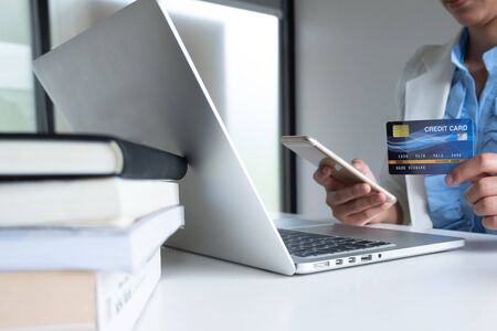 woman use credit card for online shopping on her laptop and phone.の写真素材