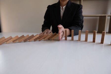 hand stop blocks wood game, gambling placing wooden block. Concept Risk of management and strategy plan, protect business to success.の写真素材