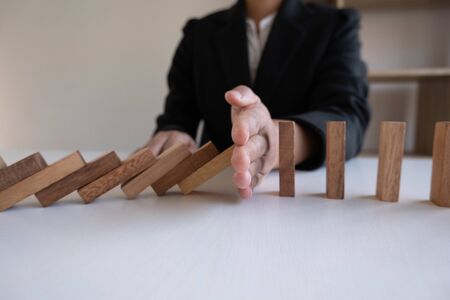 hand stop blocks wood game, gambling placing wooden block. Concept Risk of management and strategy plan, protect business to success.の写真素材